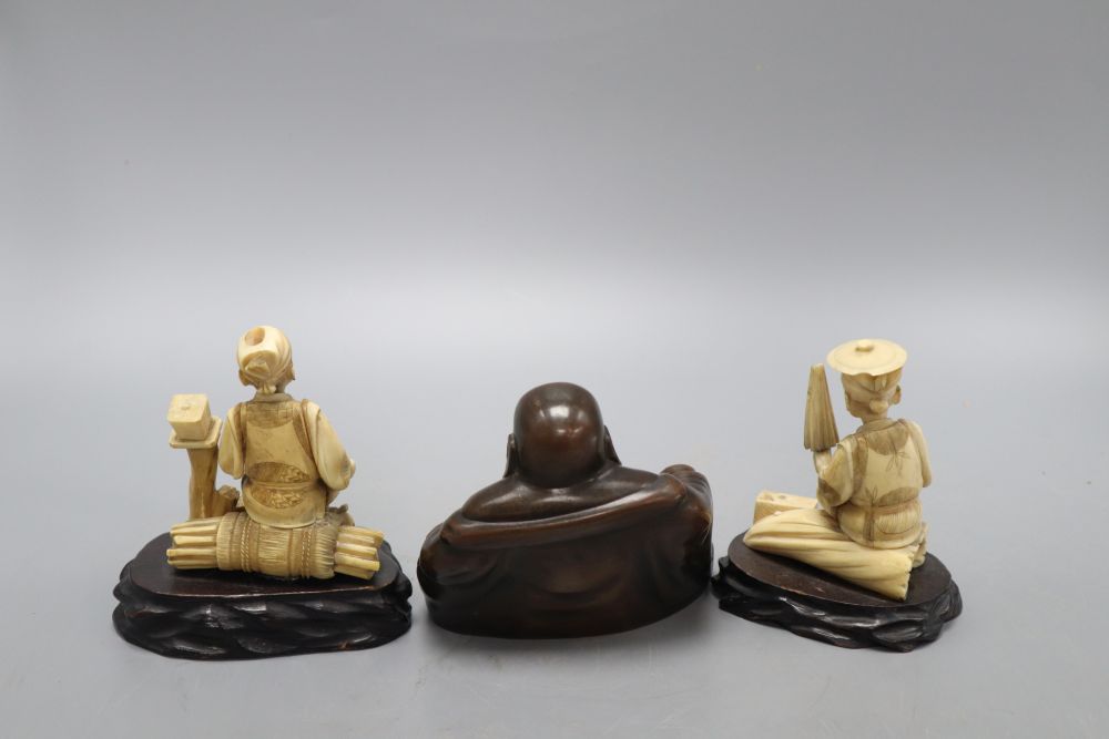 A Chinese bronze figure of a Budai and two Japanese carved ivory figures on stand